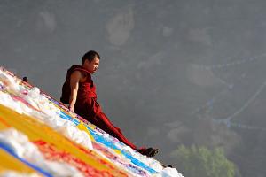 monk sitting on slope